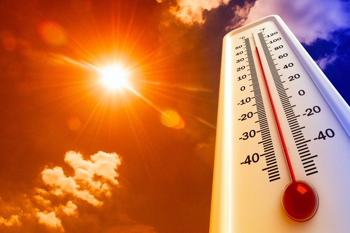 Thermometer showing high temperature under a bright sun in the sky